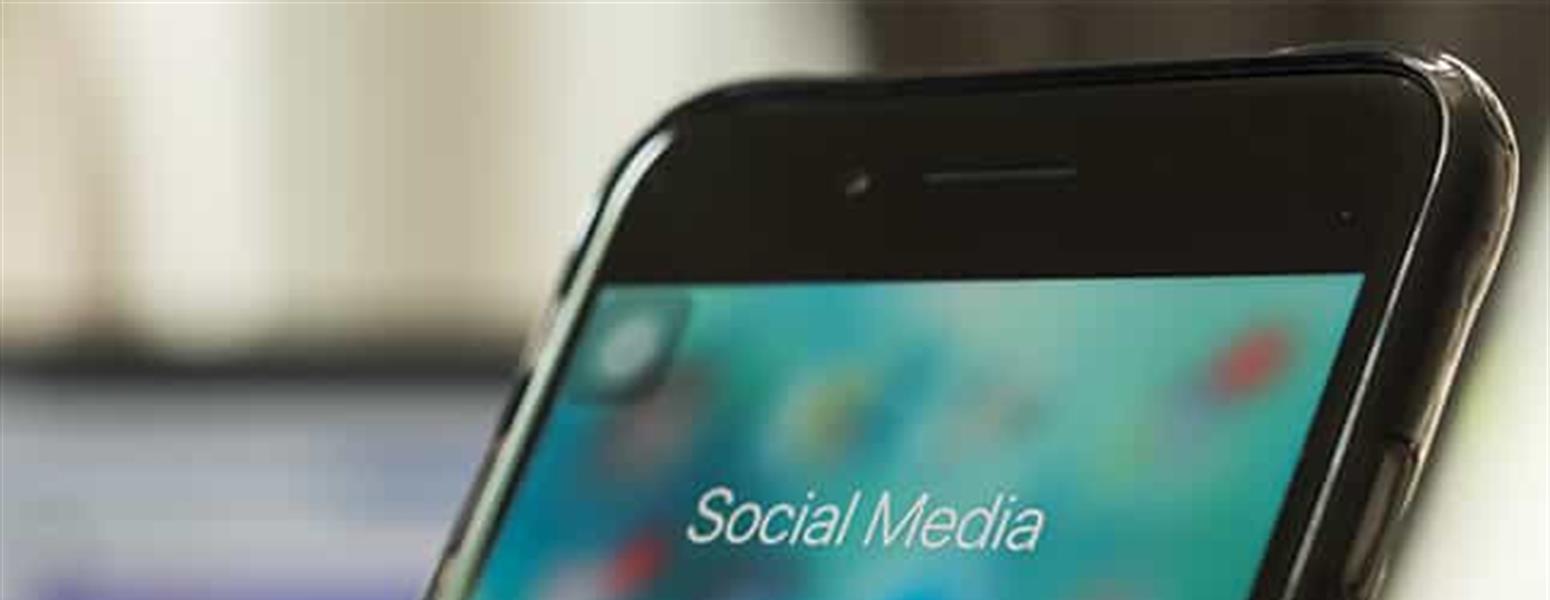 Close up on an iPhone with social media icons