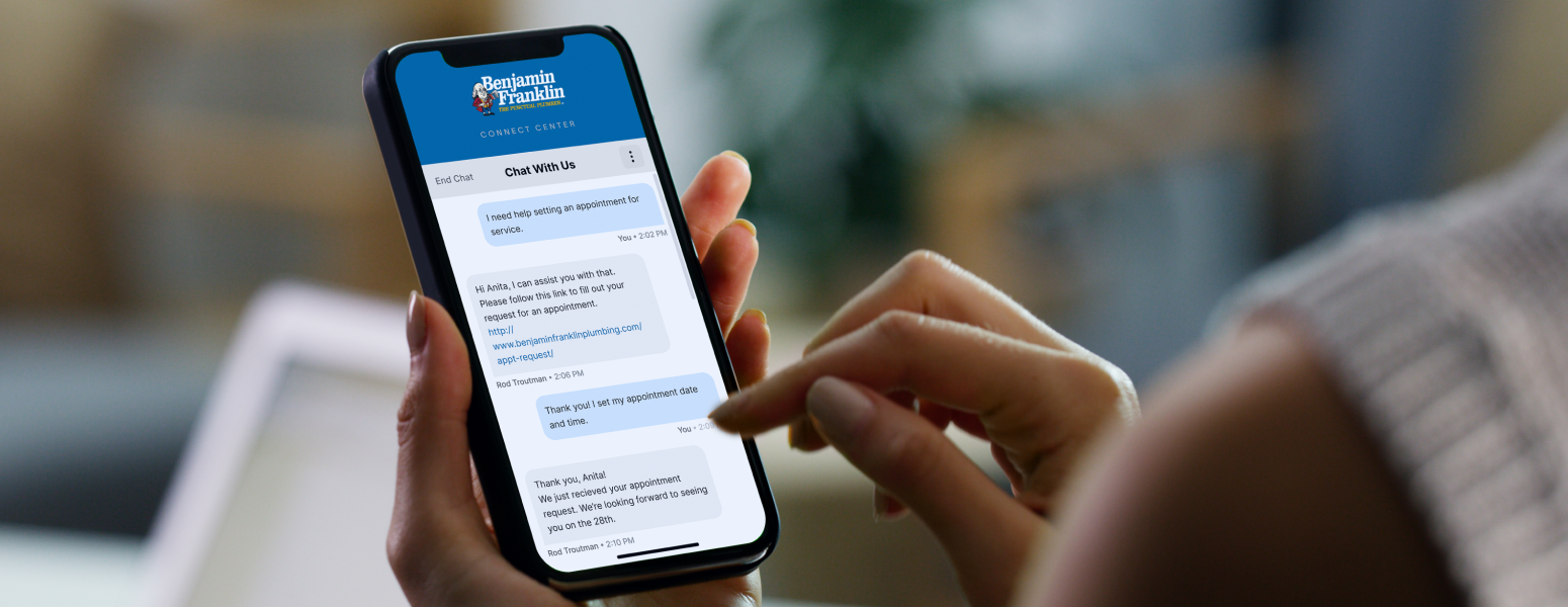 A person typing on their phone in a chat