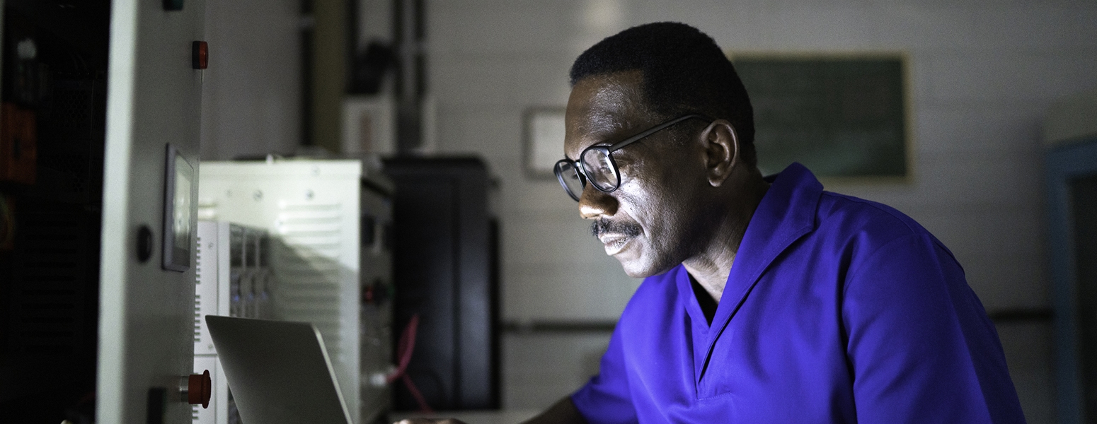 Man on a computer in an industrial workshop