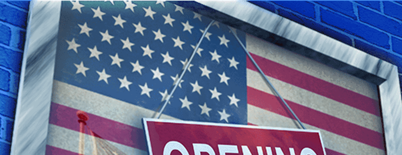 The american flag with an opening soon sign in the front.