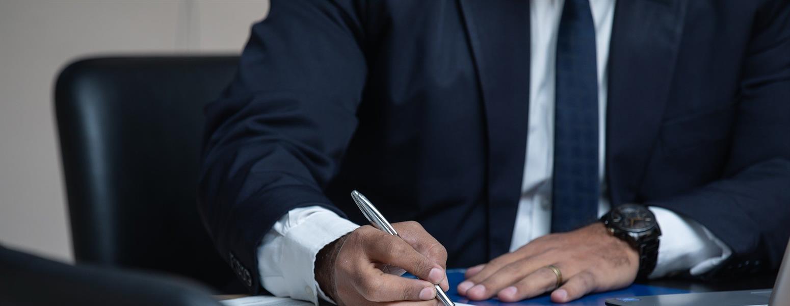 man writing with pen