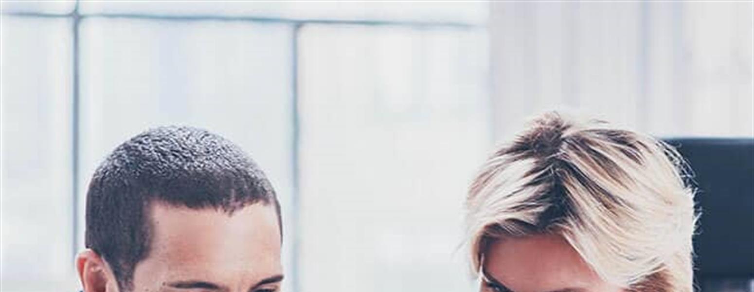 Image of man and woman looking at laptop
