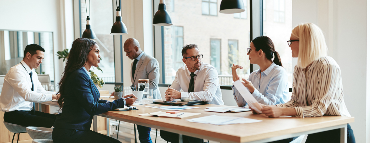A group of people around a conference table