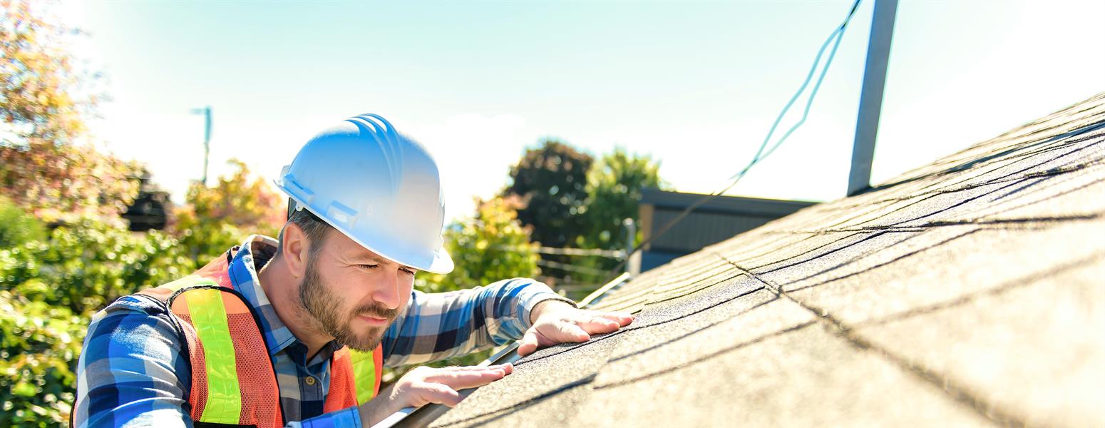 A worker fixing a roof