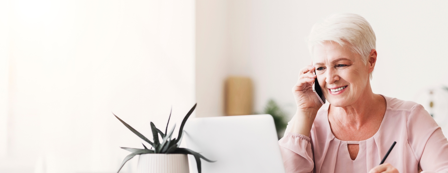Lady using a phone and computer