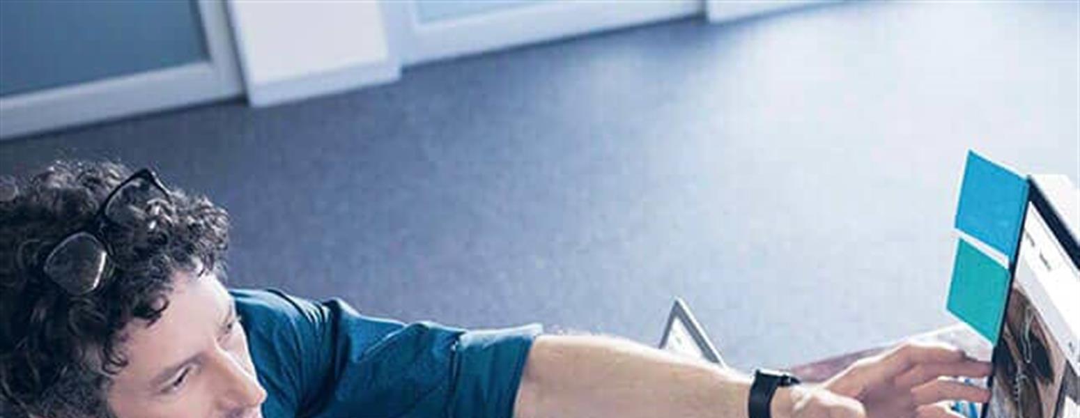 image of two people collaborating in front of computer