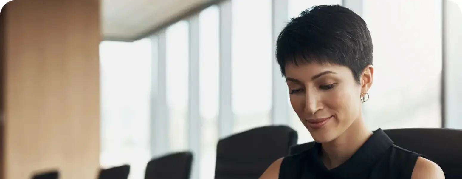 Young woman using mobile phone in office environment