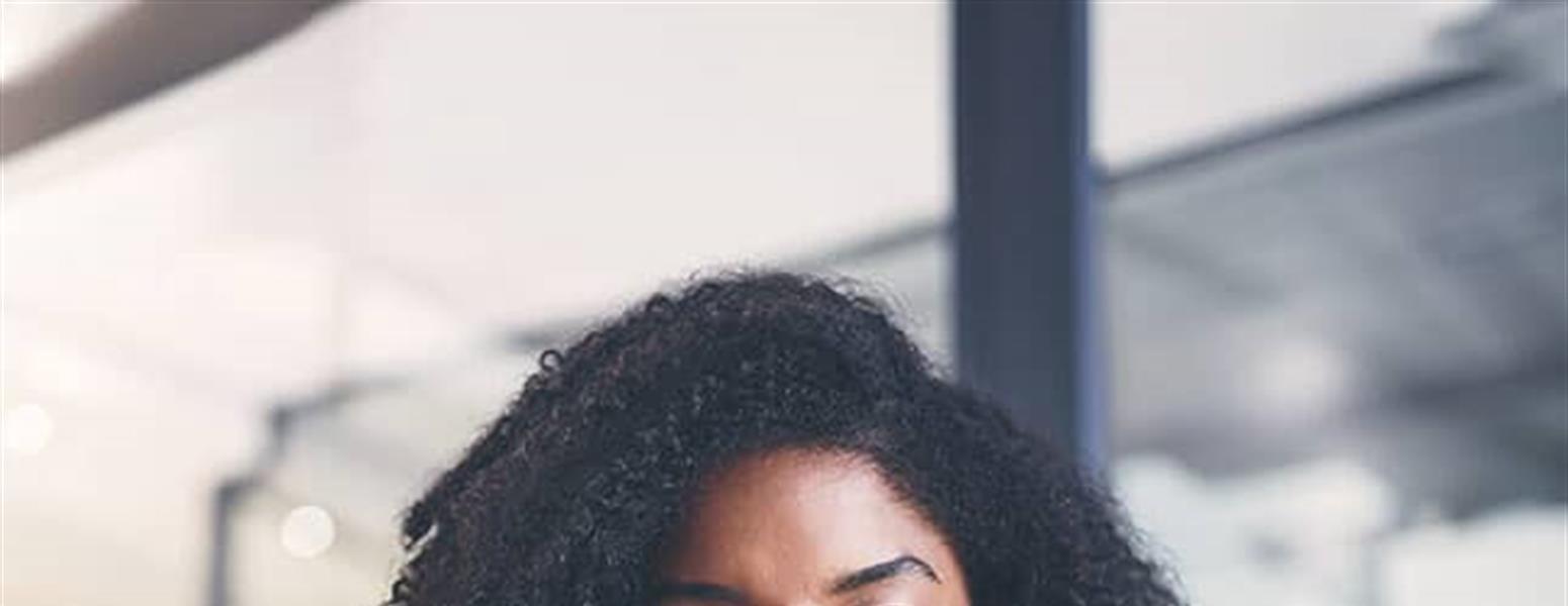 Young woman using mobile phone in office environment