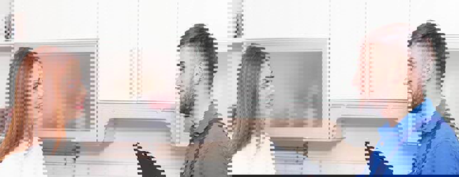 Man with Clipboard Speaking with client
