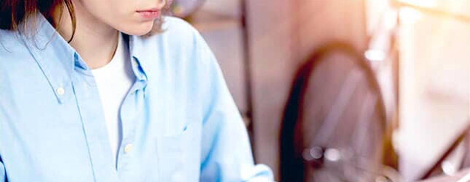 Woman in blue shirt on laptop