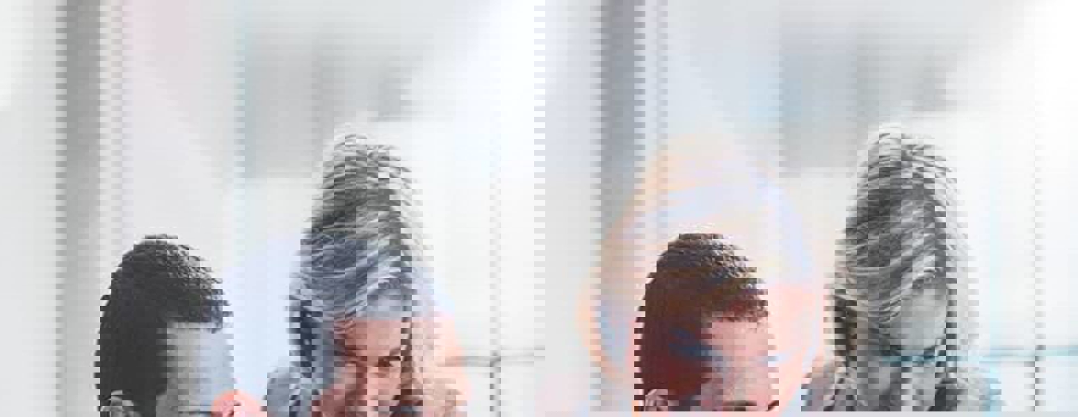 Man and Woman looking at a Laptop