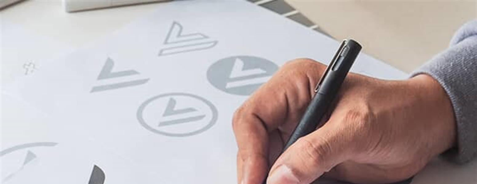 man hand drawing logo developing a brand