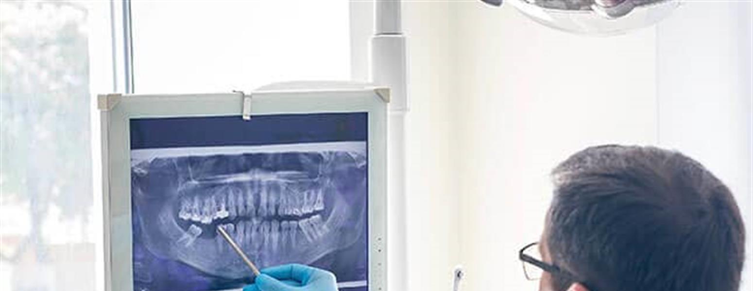 Dentist looking over x-rays with a patient