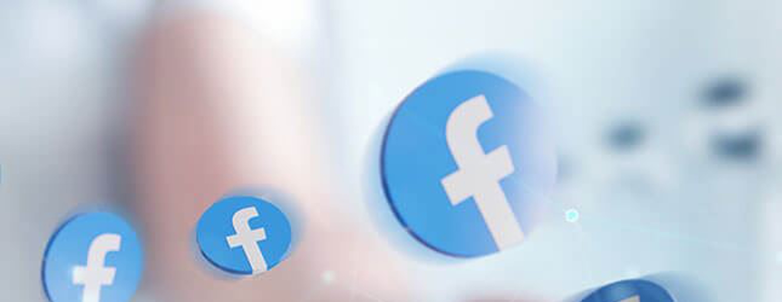 Floating Facebook logos above a Hand.