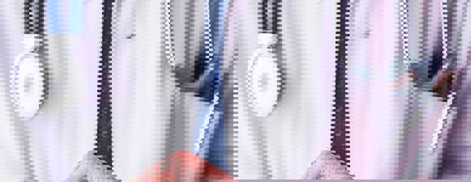A dentist looking at their phone.
