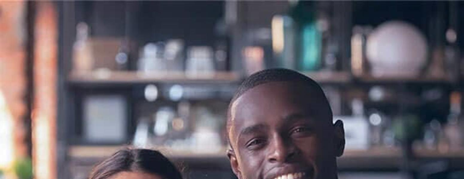 smiling man and woman wearing aprons