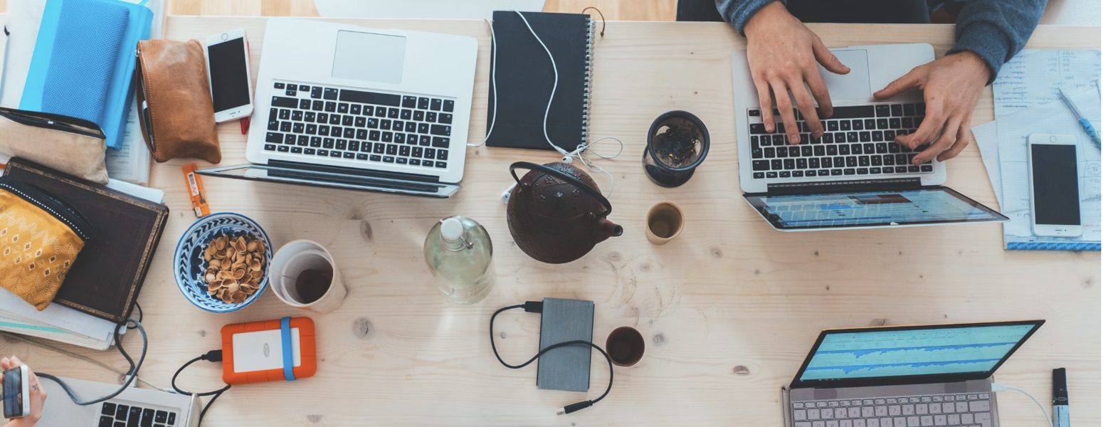 Image of a table with laptops and work stations