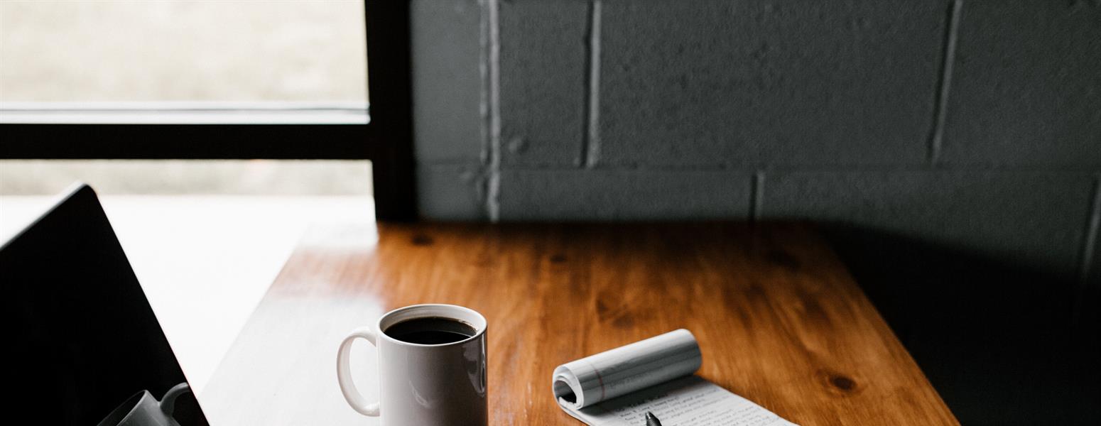 A computer, phone and notepad