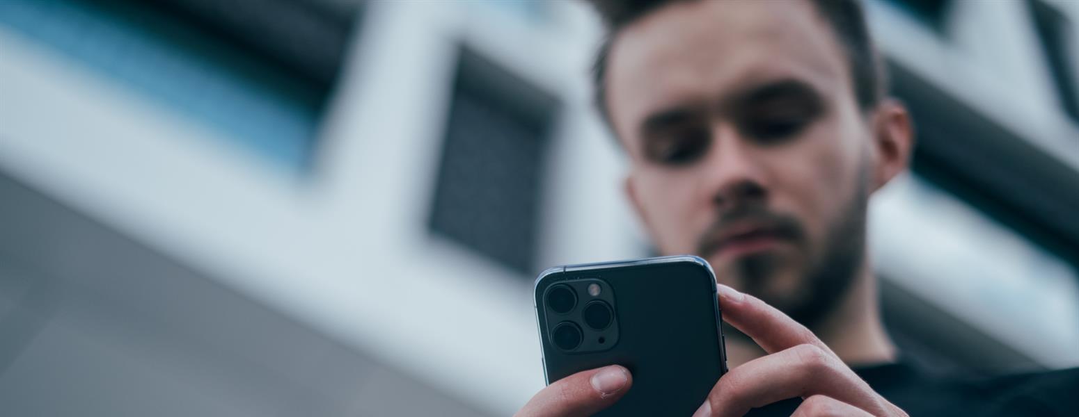 Man looking at reviews on iPhone