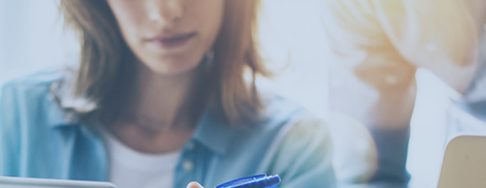 2 individuals looking over a document on an iPad