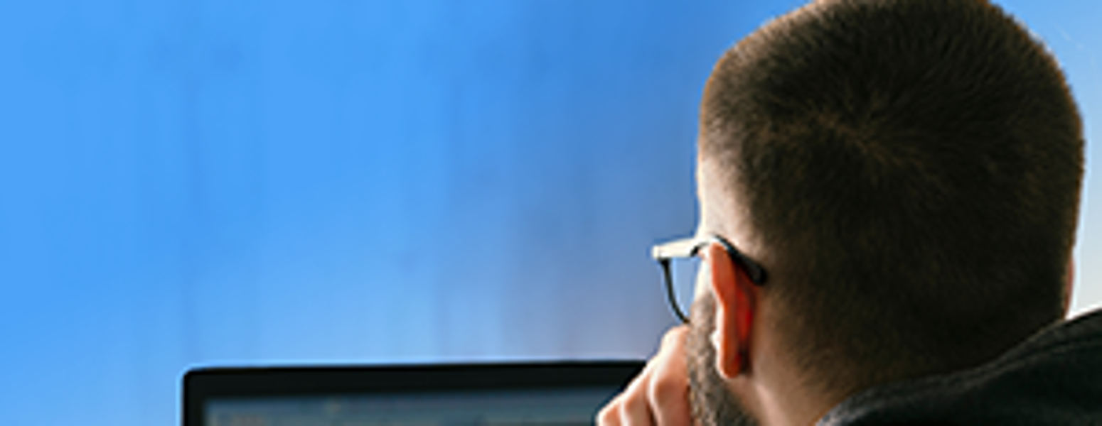 Person automating home services business on laptop at job site