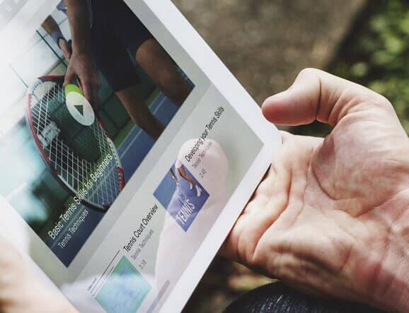 guy holding white ipad