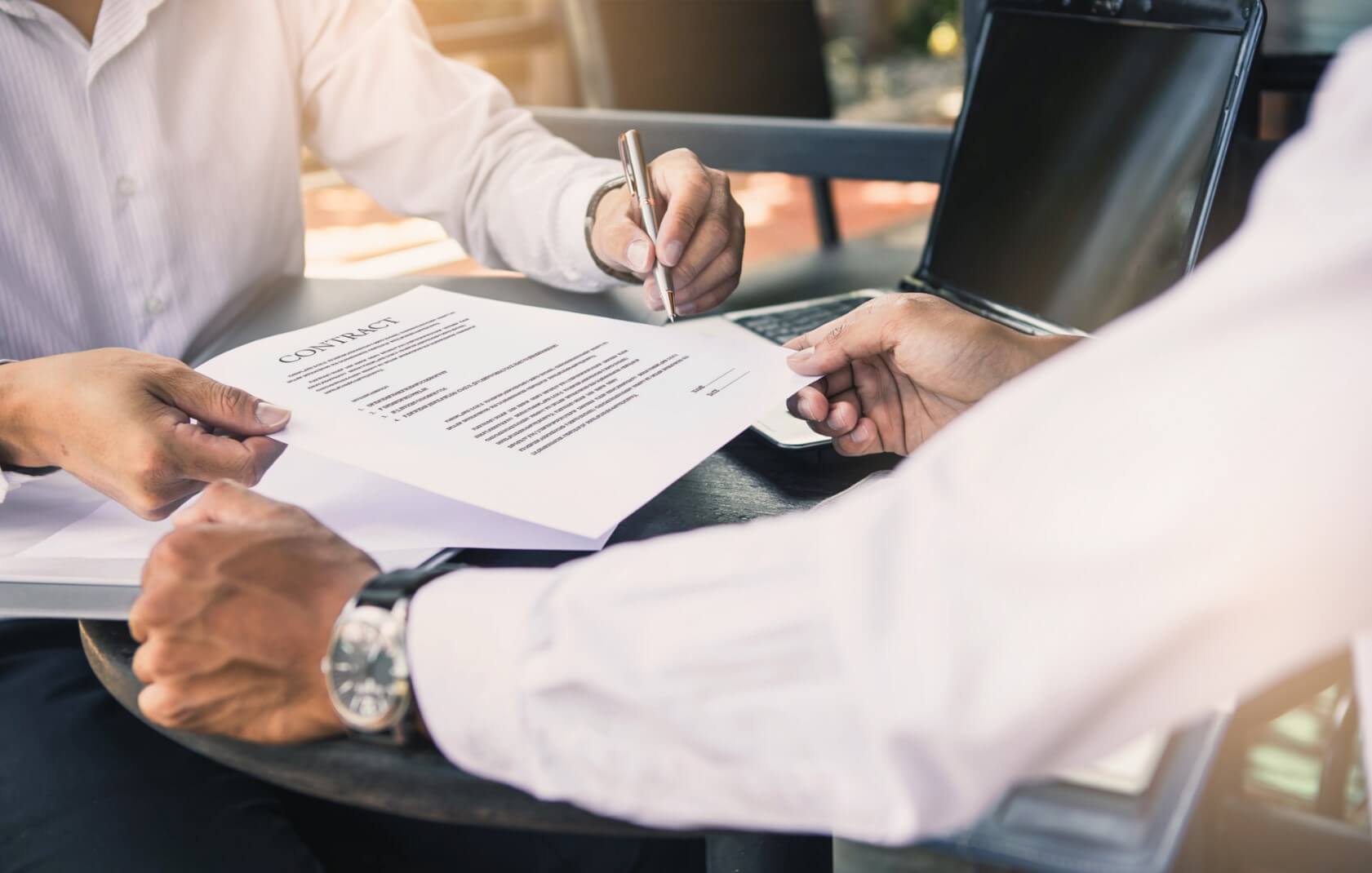 Two people looking over a contract