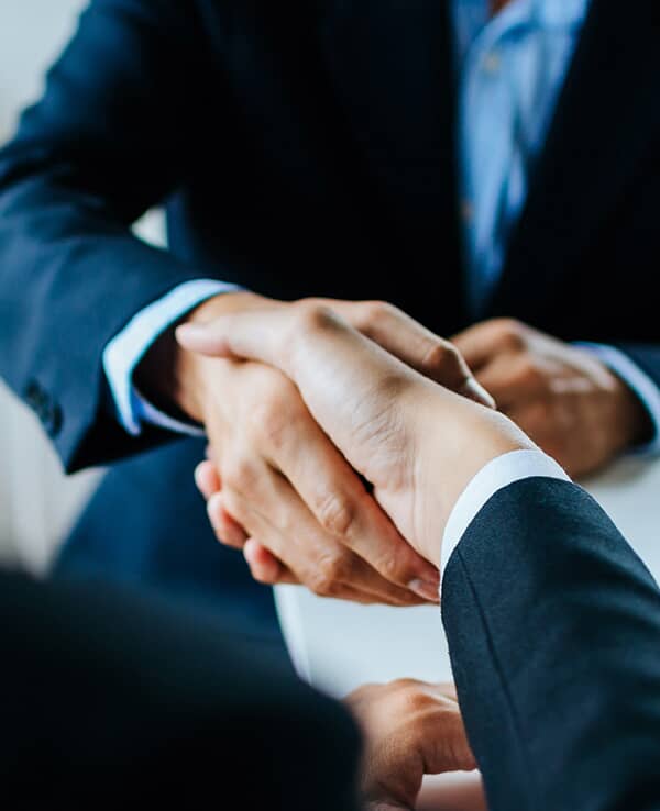 2 people shaking hands.