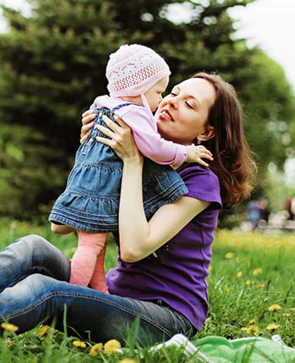 Mother and daugther playing in field