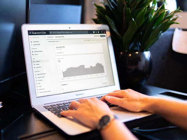 An image of someone looking at their data analytics on their laptop. 