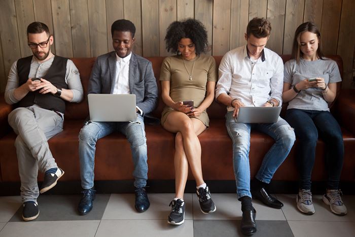 A group of people on an electronic device. 