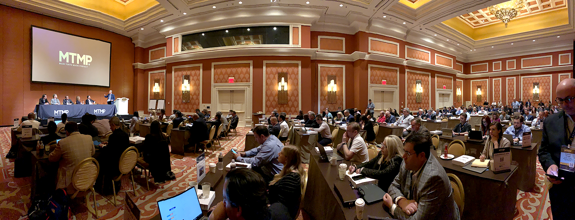 Panoramic view of a large crowd attorneys sitting in banquet room