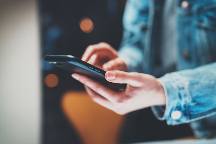 Man typing on a phone. 