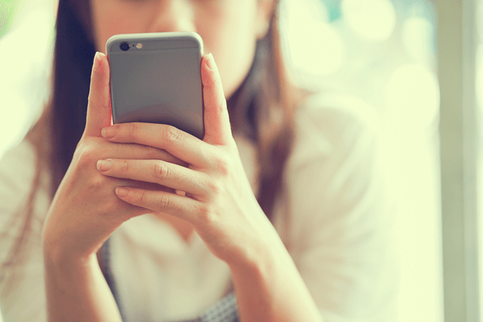 young woman looking at her cell phone