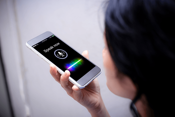 A women talking to a phone's voice assistant.