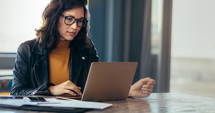 A woman looking at her laptop.