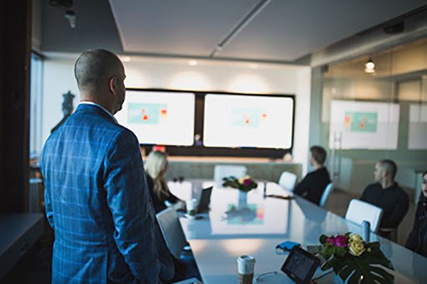 Scorpion owner and employees in a conference room