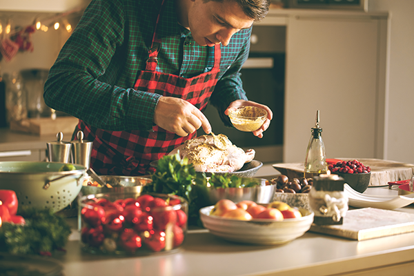 A man preparing a holiday dinner. 