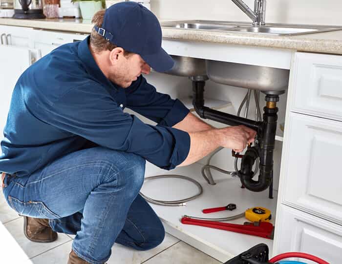 Plumber fixing a sink