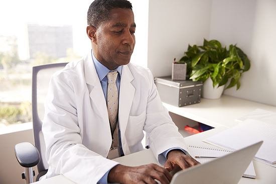 An image of a doctor on a laptop.
