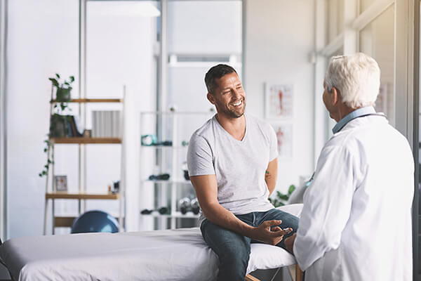 An image of a doctor interacting with a patient. 