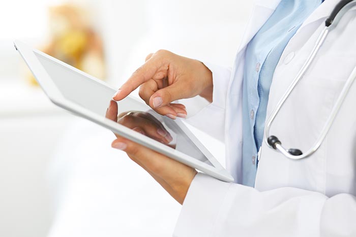 image of doctor looking at tablet