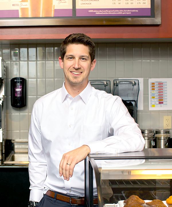 franchisor leaning on counter